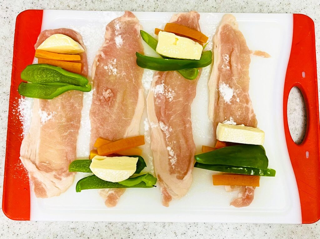 コストコのミニブリーチーズのアレンジレシピ。豚ロースで巻いているところ