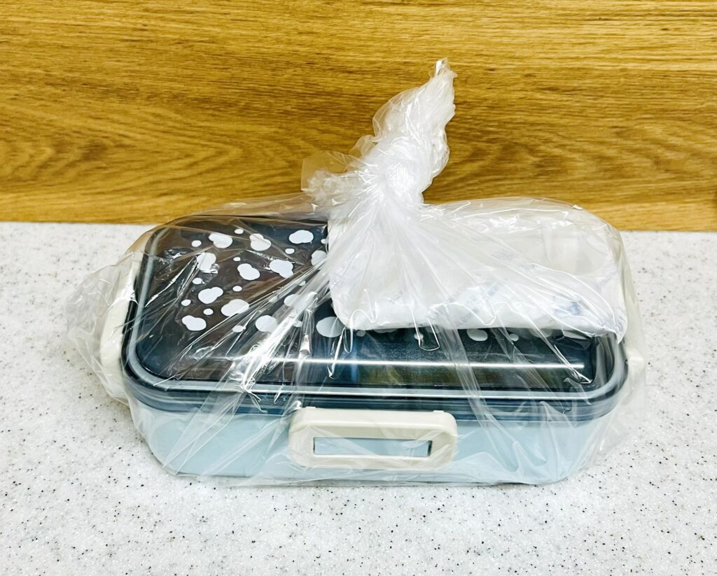 お弁当の保冷の仕方。おかず側に保冷剤をのせてビニール袋で固定